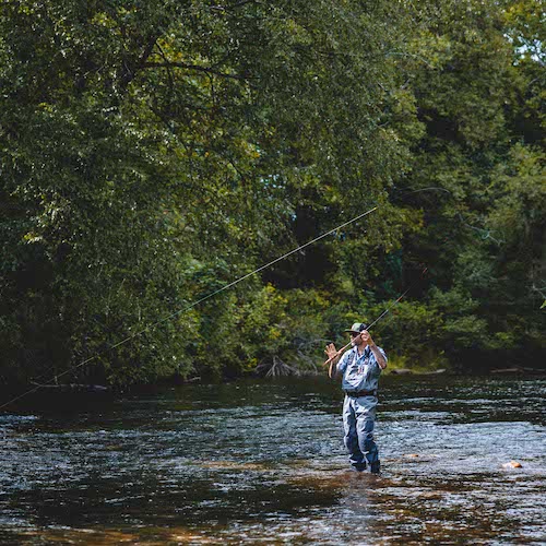 man fly fishing in a stream